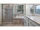Modern bathroom showcasing a tiled shower, soaking tub, and vanity with dual sinks at 1711 Lake Sims Pkwy, Ocoee, FL 34761