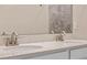 Close-up of a modern bathroom vanity with dual sinks and marble countertops at 1711 Lake Sims Pkwy, Ocoee, FL 34761