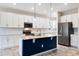 Open kitchen featuring a center island, stainless steel appliances, and white cabinets at 1711 Lake Sims Pkwy, Ocoee, FL 34761