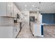 Bright kitchen with white cabinets, tiled backsplash, stainless steel appliances, and an island with sink at 1711 Lake Sims Pkwy, Ocoee, FL 34761