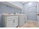 Well-equipped laundry room with appliances, sink, and ample storage space at 1711 Lake Sims Pkwy, Ocoee, FL 34761