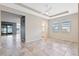 Bright living room with tile flooring, tray ceiling, and ample natural light at 1711 Lake Sims Pkwy, Ocoee, FL 34761