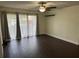 Living room featuring dark hardwood floors, sliding glass doors, curtains, a ceiling fan, and track lighting at 1714 Pine Ridge Rd, Sanford, FL 32773