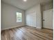 Bedroom featuring hardwood floors, natural light, and closet at 17325 Sw 41St Cir, Ocala, FL 34473