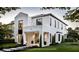 Elegant white modern home with black framed windows, manicured lawn, and beautifully landscaped front yard at 2102 S Osceola Ave, Orlando, FL 32806