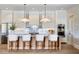 Bright kitchen with a center island, white cabinets, stainless steel appliances, and modern pendant lighting at 2102 S Osceola Ave, Orlando, FL 32806