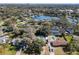 Aerial view of lakefront homes, showcasing mature trees, sparkling pool, and serene environment at 215 Nob Hill Cir, Longwood, FL 32779