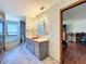 Bathroom view with red sink, marble floor, tub, and silver accented wallpaper at 215 Nob Hill Cir, Longwood, FL 32779