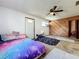 Bedroom view with ceiling fan, wood paneled wall, white door, and air conditioner at 215 Nob Hill Cir, Longwood, FL 32779