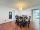 Dining room showcasing a modern chandelier and a dark wood table with six chairs and hardwood floors at 215 Nob Hill Cir, Longwood, FL 32779