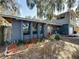 Well-maintained two-story home featuring a charming red front door and a landscaped yard with mature plants at 215 Nob Hill Cir, Longwood, FL 32779