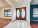 Foyer with tiled floor and double doors leading to rooms with wood floors at 215 Nob Hill Cir, Longwood, FL 32779