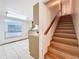 Hallway with staircase to the second floor and a view of the adjacent kitchen at 215 Nob Hill Cir, Longwood, FL 32779