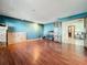 Spacious living room with hardwood floors, blue accent wall, and glass panel doors to the adjacent room at 215 Nob Hill Cir, Longwood, FL 32779
