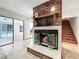 Living room featuring a brick fireplace and mantle, sliding glass doors, and a staircase to the second floor at 215 Nob Hill Cir, Longwood, FL 32779