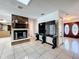Living room featuring a brick fireplace, tile flooring, and a console table under a large television at 215 Nob Hill Cir, Longwood, FL 32779