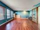 Spacious living room with rich wood floors, multiple windows, and modern lighting at 215 Nob Hill Cir, Longwood, FL 32779