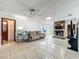 Living room with brick fireplace, ceiling fan, and tile flooring perfect for relaxing and entertaining at 215 Nob Hill Cir, Longwood, FL 32779
