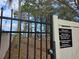 Gated playground with hours posted and equipment visible through the fence at 215 Nob Hill Cir, Longwood, FL 32779