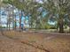 Community playground featuring swings, a slide, and picnic tables under mature trees at 215 Nob Hill Cir, Longwood, FL 32779