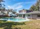 Inviting backyard featuring a sparkling swimming pool, patio furniture, and a well-maintained lawn, perfect for relaxation at 215 Nob Hill Cir, Longwood, FL 32779