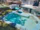 Aerial view of backyard featuring a refreshing swimming pool and outdoor dining area, perfect for outdoor entertaining at 215 Nob Hill Cir, Longwood, FL 32779