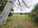 A black metal fence encloses a private property, ensuring security and exclusivity amidst lush greenery at 215 Nob Hill Cir, Longwood, FL 32779