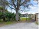Iron gate leading to a serene green space, surrounded by a lush tree and manicured greenery at 215 Nob Hill Cir, Longwood, FL 32779