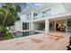 The back exterior features a contemporary home with a pool, wooden deck, and a seamless indoor-outdoor living space at 229 Alexander Pl, Winter Park, FL 32789