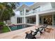 Beautiful backyard with a sleek pool, wooden deck, modern furniture, and manicured landscaping at 229 Alexander Pl, Winter Park, FL 32789