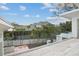 Relaxing balcony with glass railing offering serene views of the landscaped backyard at 229 Alexander Pl, Winter Park, FL 32789