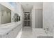 Luxurious bathroom featuring marble floors, dual sinks, and a soaking tub at 229 Alexander Pl, Winter Park, FL 32789