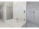 Elegant bathroom with marble tile, soaking tub, walk-in shower, and sleek storage at 229 Alexander Pl, Winter Park, FL 32789