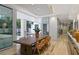 Elegant dining room with a modern table and chairs, leading to an outdoor pool area and bright, natural light at 229 Alexander Pl, Winter Park, FL 32789