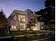 Modern two-story home with manicured lawn and beautiful landscaping at twilight at 229 Alexander Pl, Winter Park, FL 32789