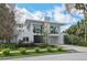 Stunning contemporary home with a modern stone facade, lush landscaping, and a clean architectural design at 229 Alexander Pl, Winter Park, FL 32789