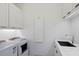 Clean laundry room with white cabinetry, a sink, and modern appliances at 229 Alexander Pl, Winter Park, FL 32789