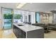 Stylish living room featuring a modern island, opening to an outdoor area with a pool at 229 Alexander Pl, Winter Park, FL 32789