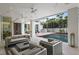 Comfortable living room flowing into an outdoor pool area, showcasing modern decor, access to outside, and backyard views at 229 Alexander Pl, Winter Park, FL 32789