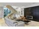 Open-concept living room with glass staircase and modern fireplace feature at 229 Alexander Pl, Winter Park, FL 32789