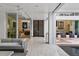 Open-concept living room with access to an outdoor lounge and a view of the pool area and modern tile flooring at 229 Alexander Pl, Winter Park, FL 32789
