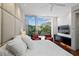 Cozy bedroom with upholstered headboard, hardwood floors, and balcony access at 229 Alexander Pl, Winter Park, FL 32789