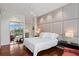 Bright main bedroom with a serene ambiance, hardwood floors, and decorative headboard at 229 Alexander Pl, Winter Park, FL 32789