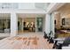 Stunning patio with wood floors, modern seating, and expansive glass doors opening to the interior at 229 Alexander Pl, Winter Park, FL 32789