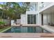 Beautiful pool area with a modern design, wooden deck, and seamless transition to the interior living space at 229 Alexander Pl, Winter Park, FL 32789