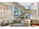 Living room with a modern staircase, stone accent wall, and comfortable seating at 229 Alexander Pl, Winter Park, FL 32789