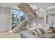 Modern staircase with glass railings and wood treads illuminated with inset lighting in a modern home at 229 Alexander Pl, Winter Park, FL 32789