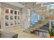 Bright foyer with floating staircase, glass railings, and unique display nooks at 229 Alexander Pl, Winter Park, FL 32789