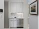 Wet bar featuring white cabinetry, marble countertops, and stainless steel appliances at 229 Alexander Pl, Winter Park, FL 32789