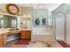 Airy bathroom featuring a walk-in shower and plenty of counter space at 25221 Quail Croft Pl, Leesburg, FL 34748